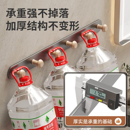 Hook-free wall-mounted stainless steel clothes hanger for kitchens and bathrooms, suitable for hanging clothes and towels on the back of doors without drilling holes.