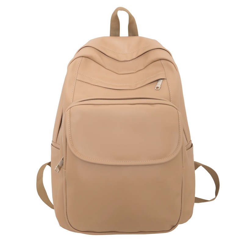 Comercio exterior al por mayor 2023 nueva versión coreana de la mochila de cuero suave para estudiantes de secundaria Mochila de computadora de gran capacidad de color sólido de moda