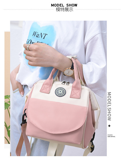 The Mommy bag is small and cute. It has a detachable front pocket and is a multi-functional baby bag. It is waterproof, lightweight, and has a crossbody design. It can be used to carry milk bags undefined