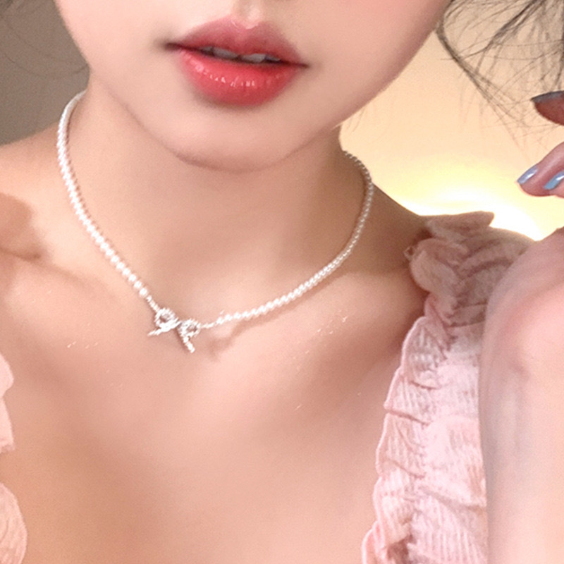 Elegant cute necklace with zircon with bow from pearl