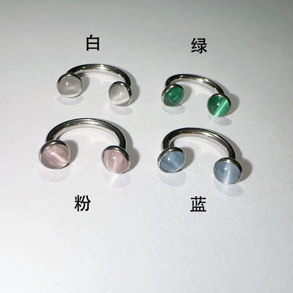 White lip piercing, cat's eye