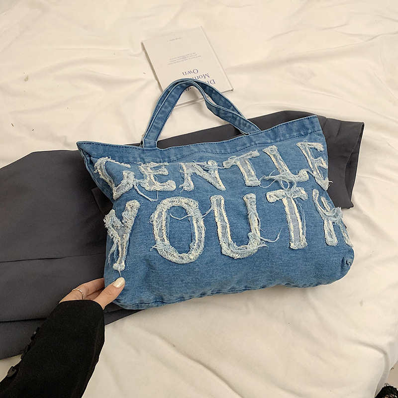 Nueva mochila de hombro de mezclilla retro, bolso de lona con letras de ocio, bolso de viaje artístico para estudiantes