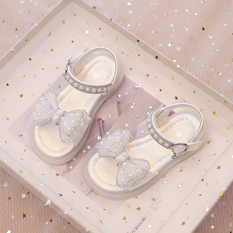 Niños verano 2026 nuevas sandalias de niñas arco brillante con base suave princesa sandalias de viento para niñas sandalias