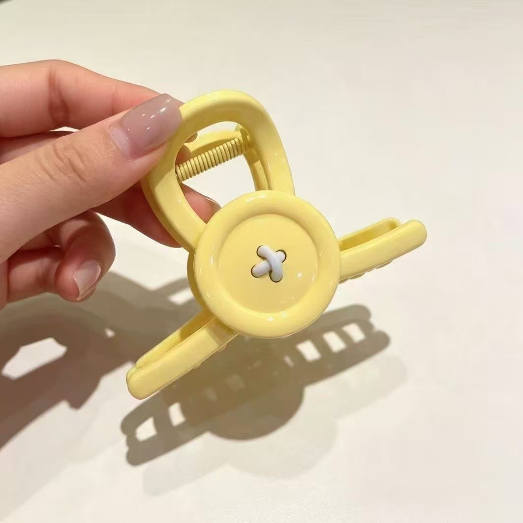 Korean-style Instagram-worthy candy-colored button hair clip, with a glossy finish, medium size, versatile for everyday wear, and designed to be clipped at the back of the head