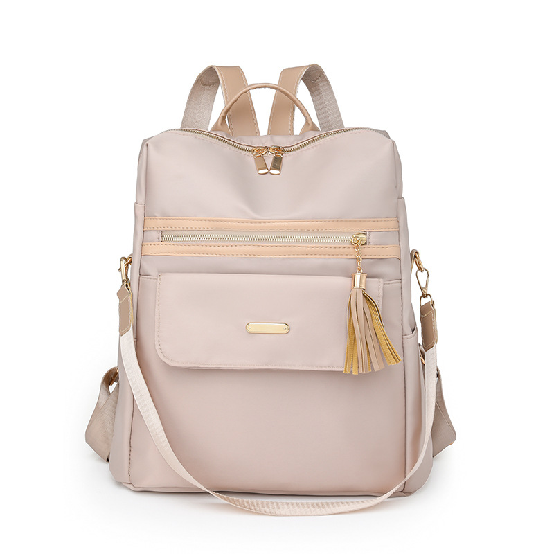 2023 nueva mochila casual para mujer nylon color contraste moda borla mochila de viaje multifuncional de doble uso al por mayor