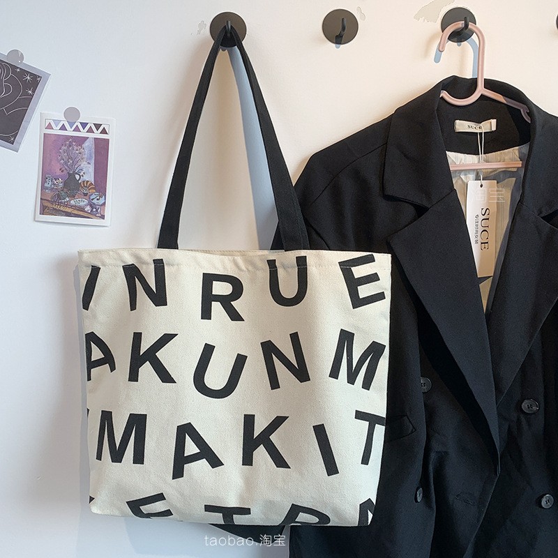 Bolsa de compras de lona de gran capacidad estilo europeo nuevo 2025 estilo ins perezoso para mujer, bolso de hombro para estudiantes, literario y simple.