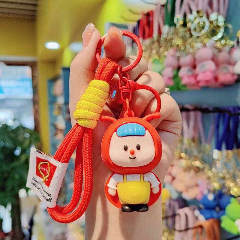 lindos dibujos animados luciérnagos llavero rojo estereoscópico muñeca de goma suave colgante de alto valor de la cara brillante pareja colgante
