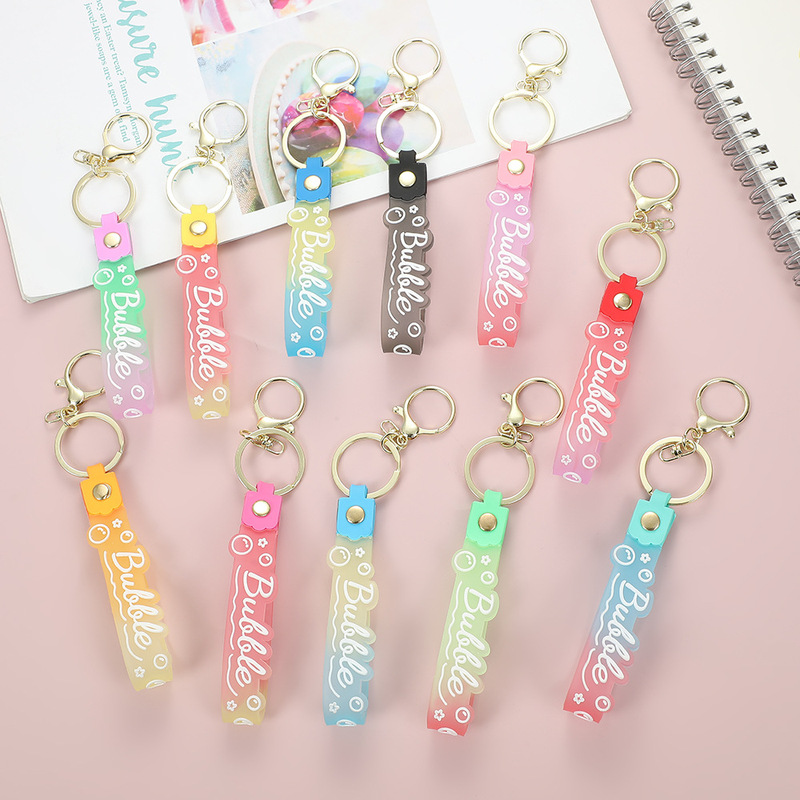 Transparent candy color pvc soft glue key chain silicone belt key chain color changing hand rope quicksand bottle small gift pendant