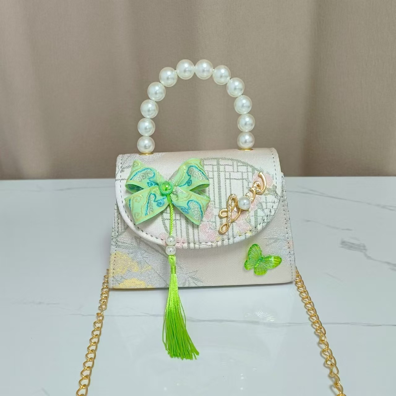 Bolsas de niños arco de estilo chino borda de niña pequeña princesa perla bolsa de cambio de mano al por mayor