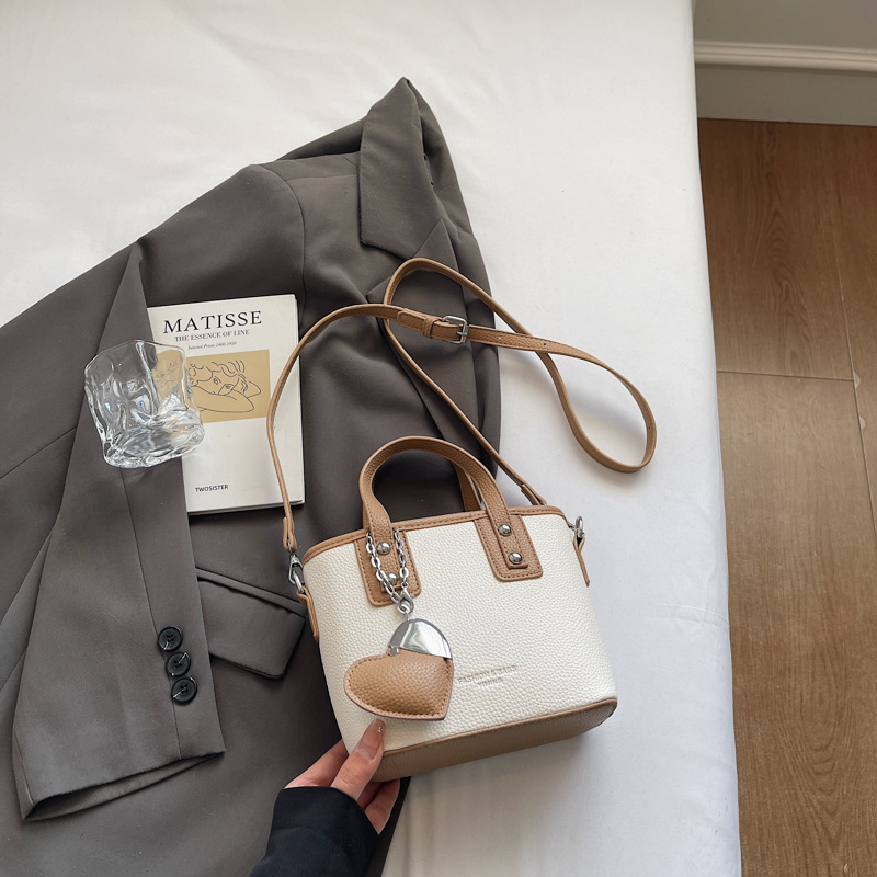 Bolso de cubo portátil transfronterizo simple y de alta gama para mujer 2025 nuevo bolso de hombro de estilo occidental de todo fósforo bolso de mensajero de moda