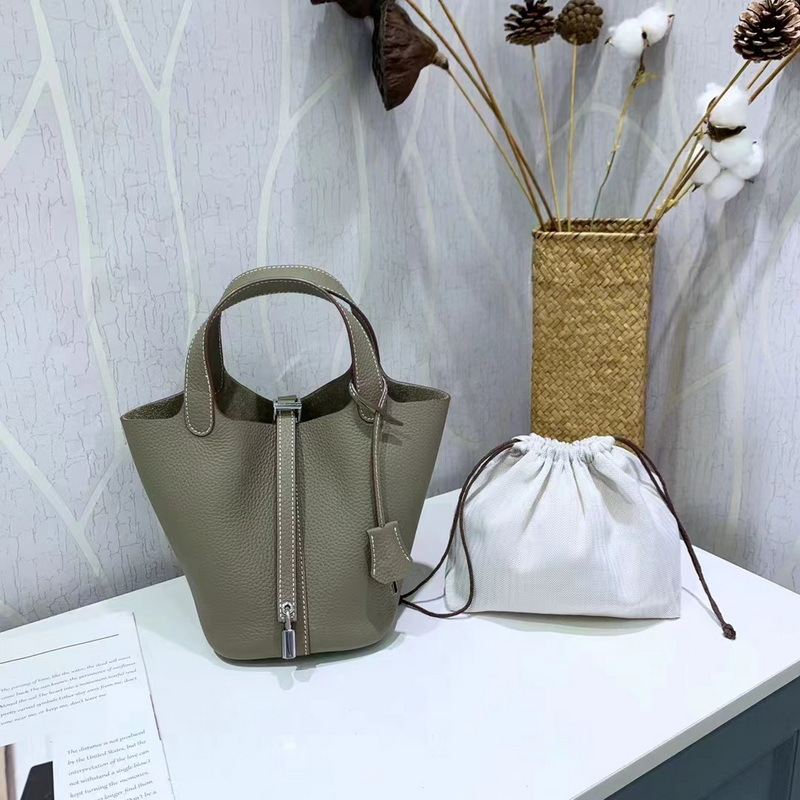 El nuevo bolso de cesta de verduras de marea de cuero togo de piel de vaca de capa superior 2025, bolso de cubo con cerradura de mano, bolso de cuero para mujer