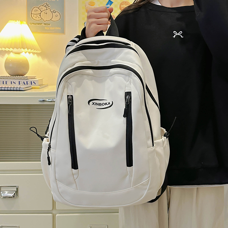 Fabricantes de mochilas escolares, estudiantes universitarias al por mayor, simples y versátiles, versión coreana de mochilas de ocio de nicho engrosadas