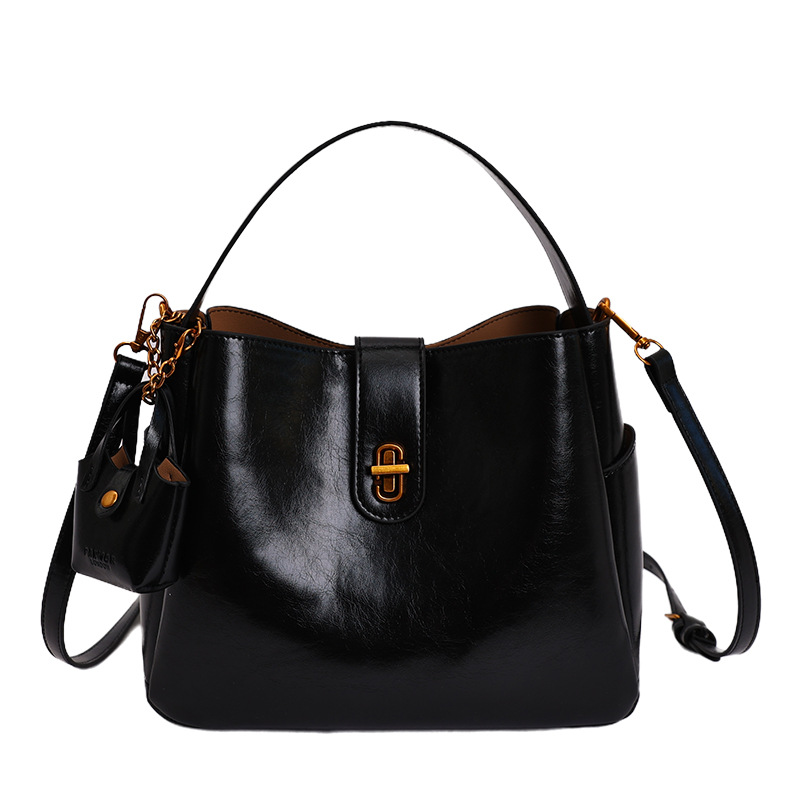 Bolsa portátil de cuero de cera retrógrada para mujeres 2026 nueva sensación de lujo ligera de alta calidad de moda versátil mochila de hombro