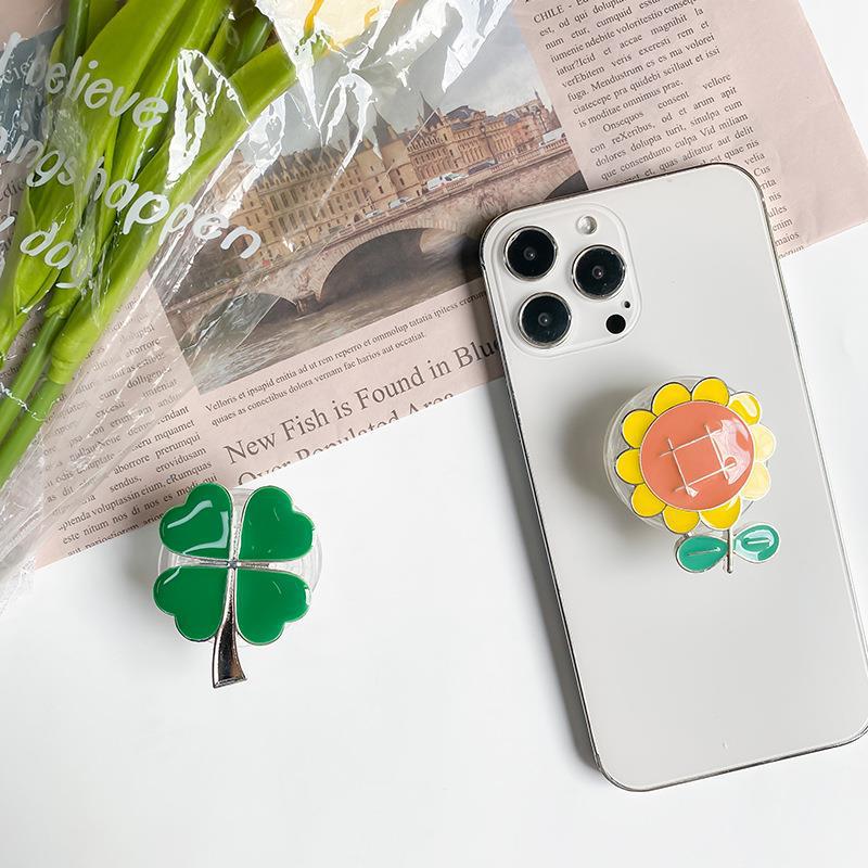 Instagram phone airbag with electroplated four leaf clover alloy sunflower desktop lazy support bracket on the back_voghion.com