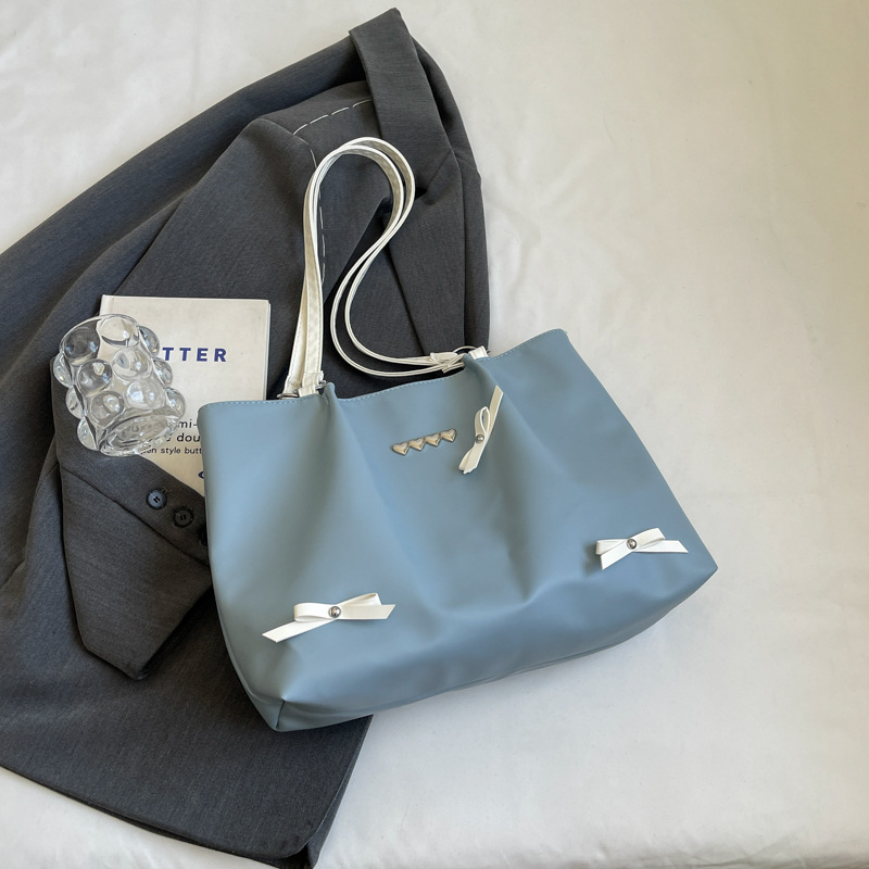Este año popular bolso de viaje de moda coreana, bolso de hombro de estilo de ballet de mujer, textura alta, arco, bolso de mano.