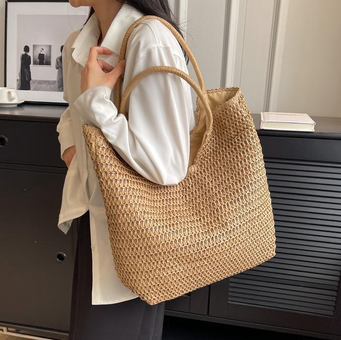 Verano simple y popular bolso de paja femenino 2025 nuevo estilo estilo occidental tejido bolso de playa bolso de viaje de gran capacidad