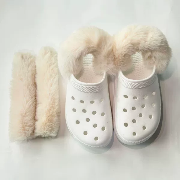 A pair of creamy white long-haired shoe covers