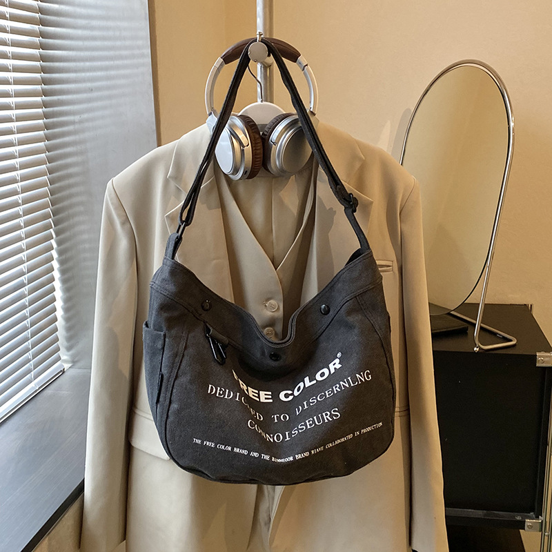 Bolsa de lona para mujeres 2026 nueva bolsa de gran capacidad transfronteriza impresa letras de viaje casual mochila de hombro