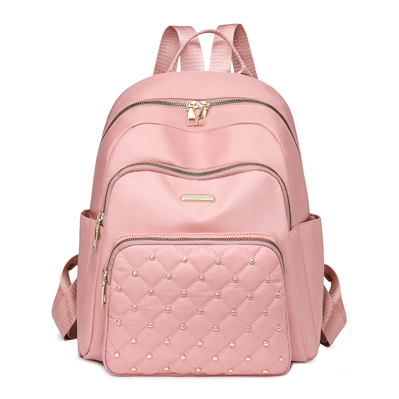 Comercio exterior al por mayor 2024 nuevo estilo casual señoras Lingge mochila moda remache color contraste mochila ligera mochila escolar marea