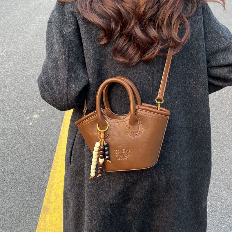 Bolsa de aire coreana para mujeres 2025, otoño y invierno, nuevo estilo de alta calidad, bolso de cubo portátil, bolso de hombro para viajar.