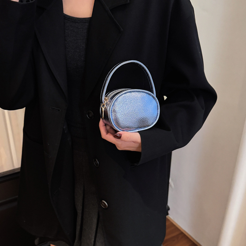 Bolso de mano de niña láser brillante simple color sólido mini bolso de cambio de bebé coreano nuevo bolso infantil transfronterizo