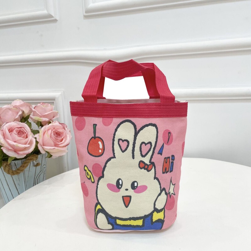 かわいい落書きバケツバッグinsプリント円筒バッグキャンバス弁当袋韓風少女は弁当箱を持っています。|undefined