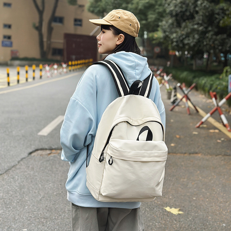 Las chicas japonesas de bolsos de lona son antiguas, impermeables, de color sólido, bolsos de nylon, Campus simple y versátil mochilas escolares para hombres de moda.