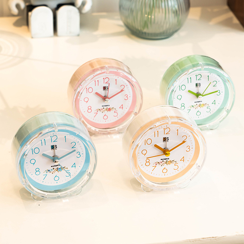 Ventas de fábrica reloj despertador de plástico redondo estudiante reloj de color caramelo con luz de dibujos animados claro reloj despertador fácil de llevar