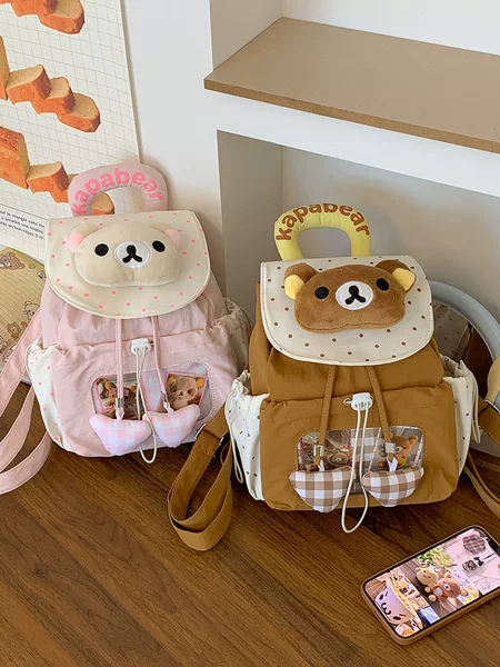 Korean-style polka dot patchwork flap backpack, featuring a cute, three-dimensional doll design, perfect for students, commuting, and outings; a portable shoulder bag