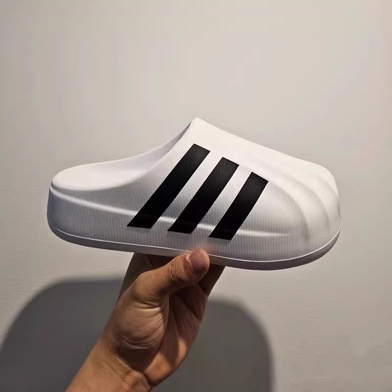 Putian EVA auténtico primavera y otoño nuevo tipo de zapatillas de cabeza de conchas de dopamina para hombres y mujeres zapatillas de agujero de fondo grueso