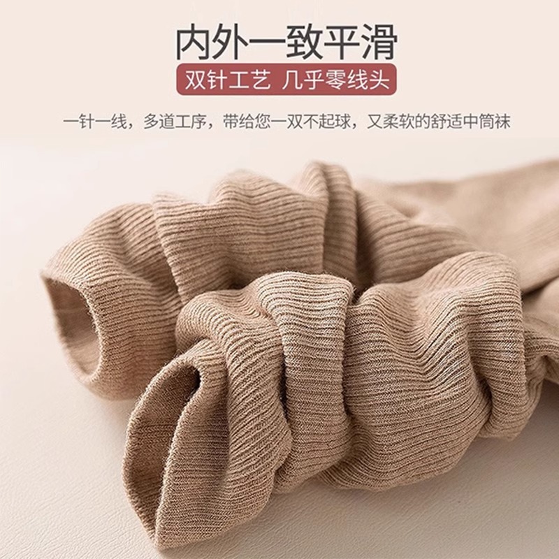 縦条のふくらはぎの靴下の女性の春秋の圧力の長い筒の靴下はやせていることができます。