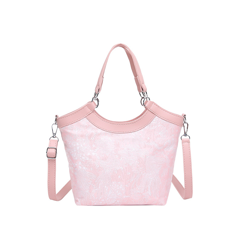 Nueva bolsa de mano de estilo chino para mujeres 2025 primavera nueva seda bordada de hombro único bolso de cubo de estilo occidental