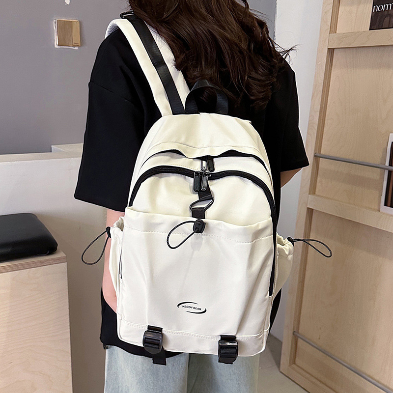 Nuevo estilo coreano transfronterizo de color sólido simple y versátil para estudiantes de escuela primaria y secundaria de alta capacidad mochila de viaje