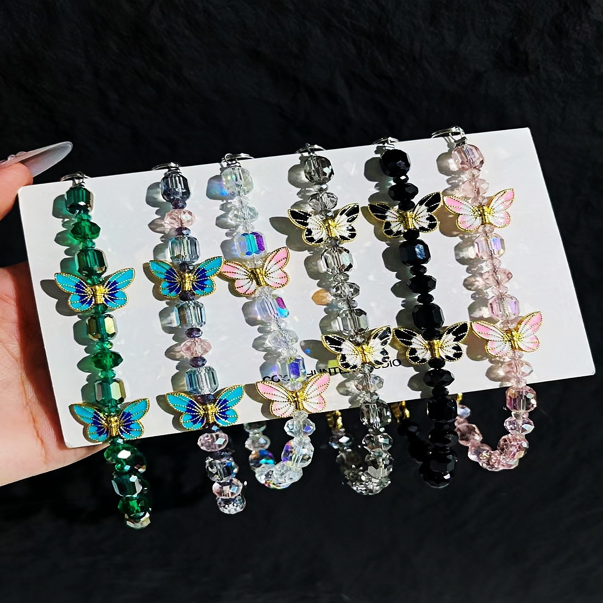 Cadena de teléfono móvil al por mayor cadena de cuentas de cristal flor de mariposa sentido de alta gama cadena corta hecha a mano para mujer bolsa de viento NIS todo fósforo