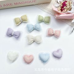 キャンディー色の布芸ネットの蝶結びの部品は綿のミニ愛を満たします。