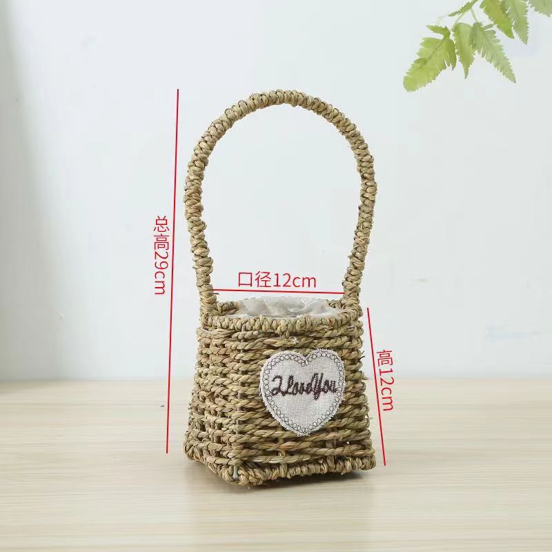 Fabricantes de cestas de flores ovales rectas de paja hechas a mano en stock al por mayor cestas de flores de paja portátiles decoración de viento pastoral