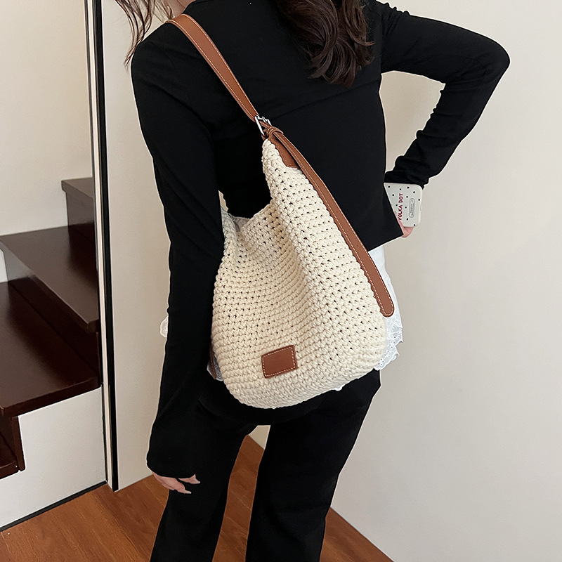 Bolso tejido hueco de estilo explosivo de verano para mujer de gran capacidad 2025 nuevo estilo de ocio junto al mar estilo vacaciones bolso tejido de paja de cercanías