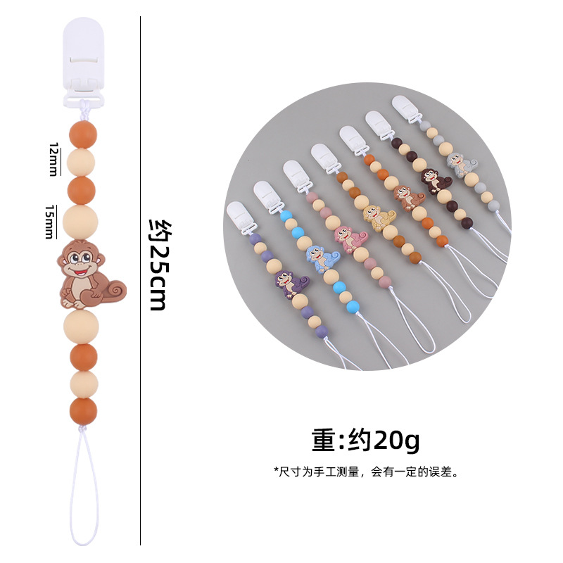 Nuevos suministros para bebés mono de dibujos animados mordedura de chupete de silicona lindo bebé creativo cadena anti-gota cadena