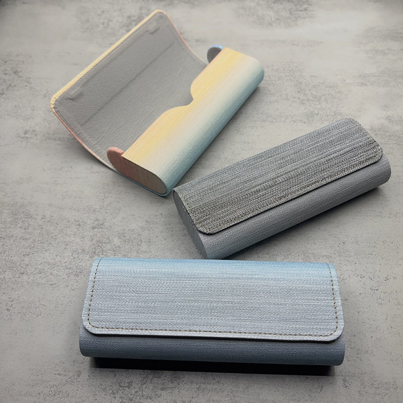 2026 nueva caja de gafas de sol de moda de cuero de dos colores bolsa blando miopía caja de ojos conjunto completo de bolsa de espejo tela