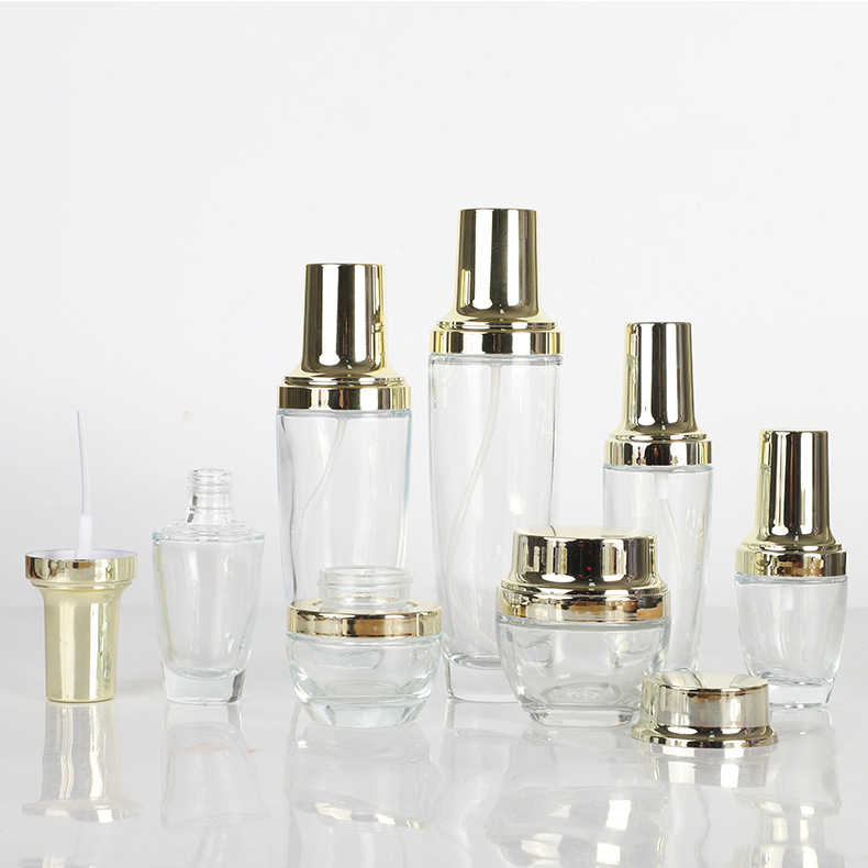 Tapa de oro transparente botella de vidrio esencia botella de loción crema cosmética crema conjunto botella aceite esencial sub-embalaje botella de spray
