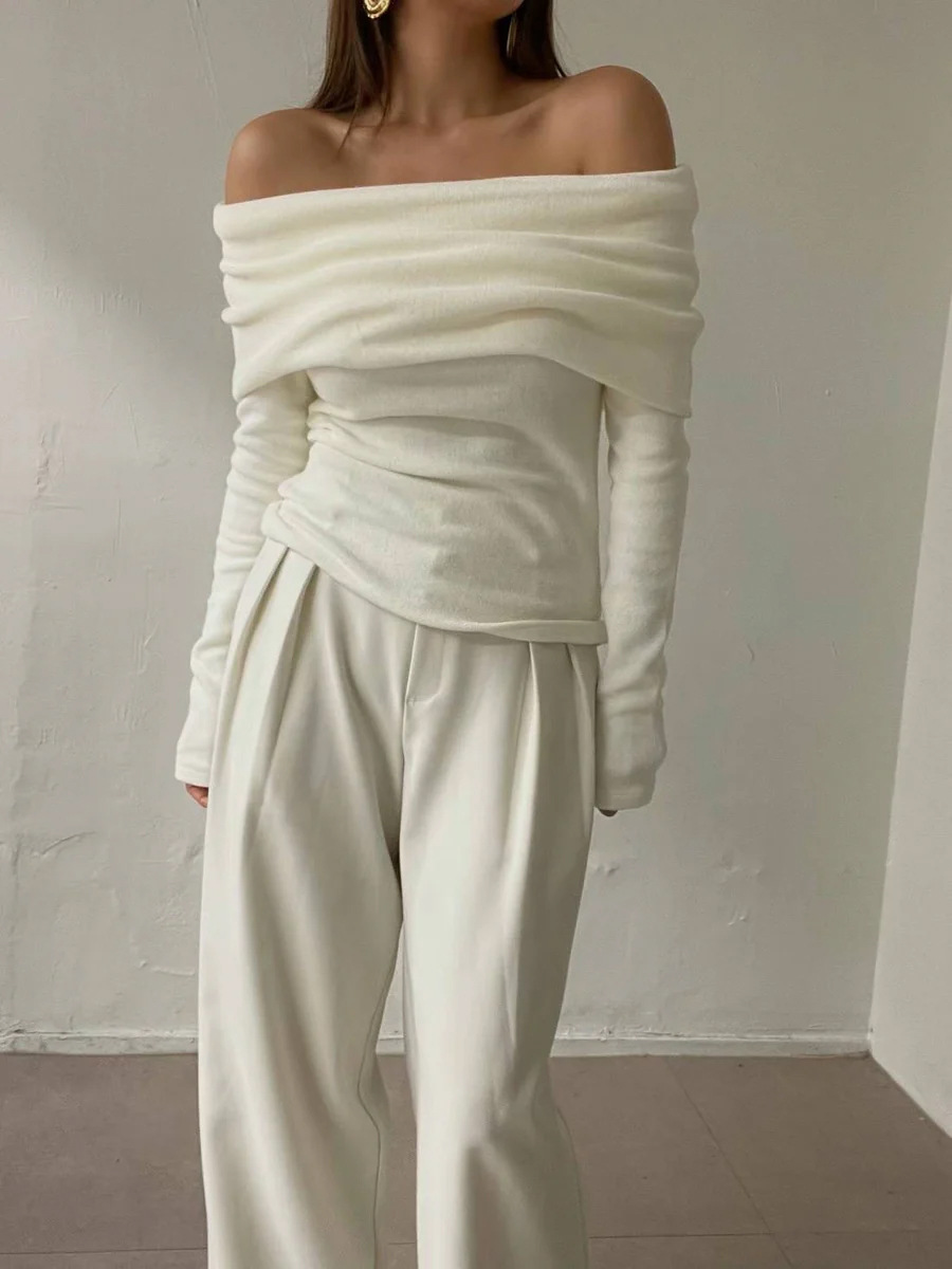 Cross-border 2026 nuevo estilo europeo y americano un hombro temperamento de diseño de hombro abierto sensación delgada envuelta en un suéter de punto de punto para mujeres