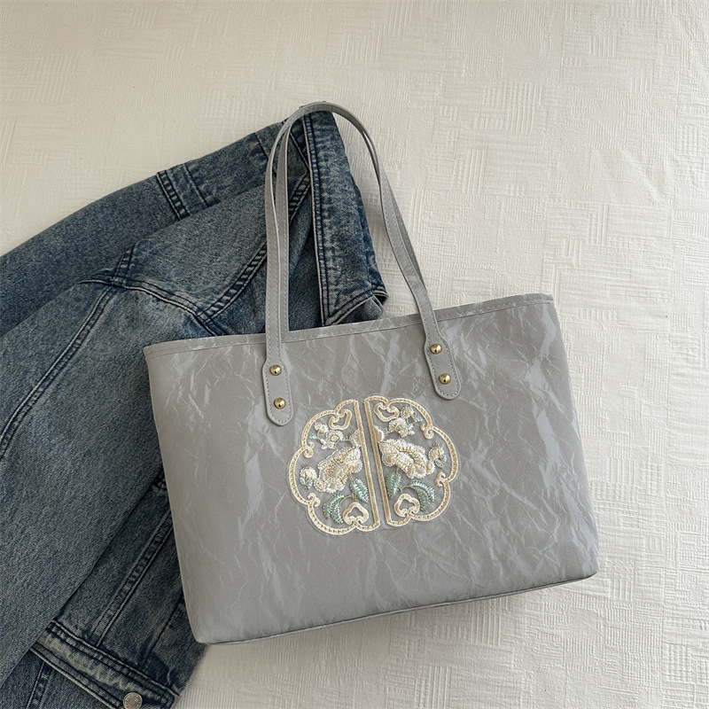 Bolsa de mano de alta calidad de alta capacidad de textura de transporte de verano 2024 nuevo estilo versátil para trabajar bolsas de hombro