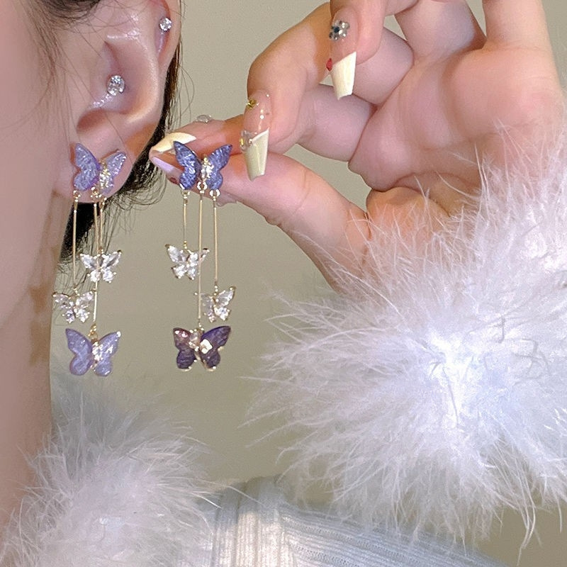 Pendientes de diseño de nicho de moda y exquisito todo fósforo Pendientes de temperamento de hadas Pendientes de borla de mariposa de cristal púrpura