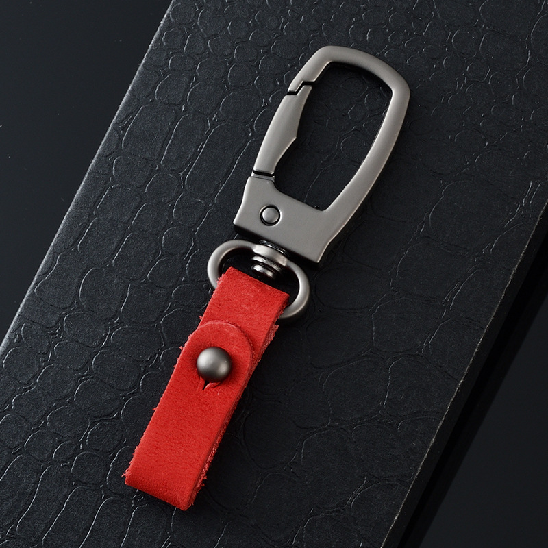 軽くて豪華な本革の自動車のキーホルダーの頭の層のつや消しの牛革の車のキーチェーンの個性のカップルの腰は掛けてペンダントをなくします。