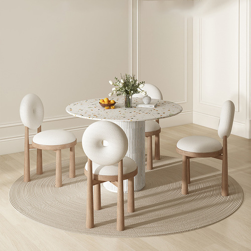 Trendy Instagram-worthy cream-colored lambswool chair set with Wabi-Sabi-style polished stone round dining table and chairs, perfect for compact spaces—featuring a sleek rock slab top paired with solid wood dining table.