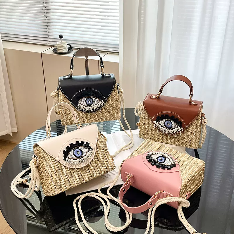 夏季编织女包2026新款日系卡通大眼睛搞怪手提包百搭斜挎沙滩包潮