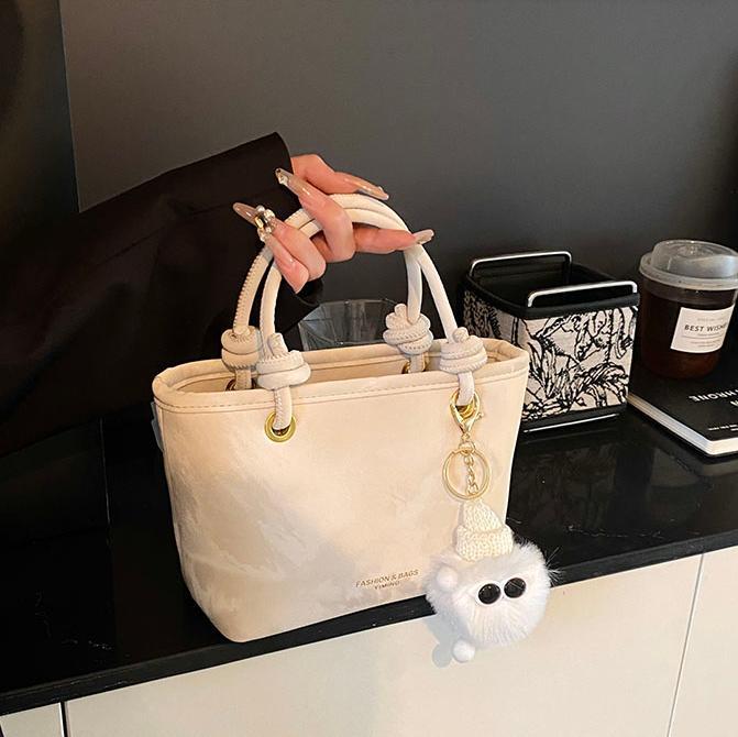 Bolso de mano casual simple coreano para damas 2025 nuevo estilo de transporte universal bolso de cubo popular mochila de hombro