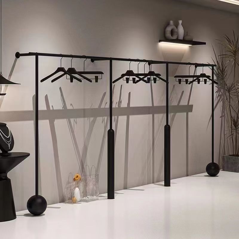 Tienda de ropa de hierro forjado estantes negros tiendas de ropa en línea especial percha de ropa de pared tienda de ropa de mujer estante de exhibición