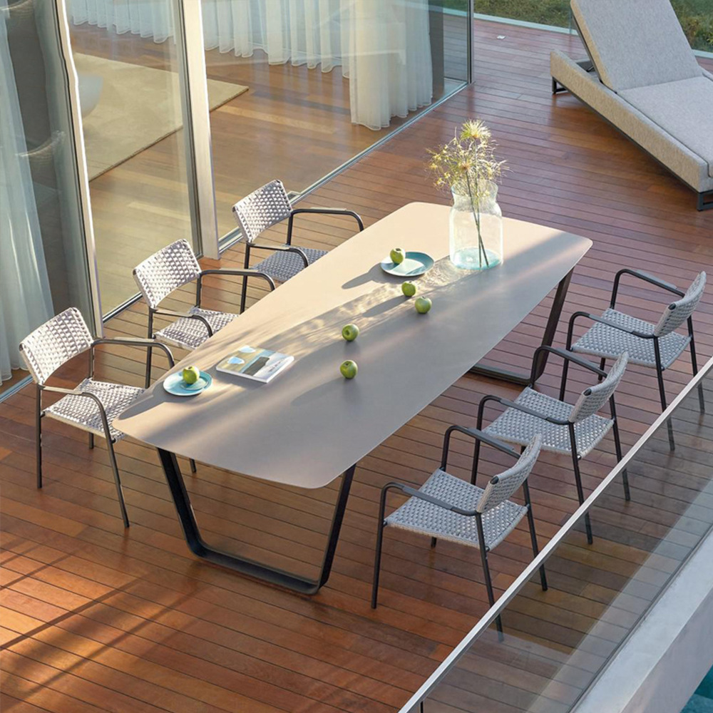 Outdoor table and chairs for patio, balcony&mdash;sunproof, waterproof, perfect for casual, open-air, or garden use&mdash;Nordic-style rattan woven wicker chairs paired with weather-resistant outdoor tables.