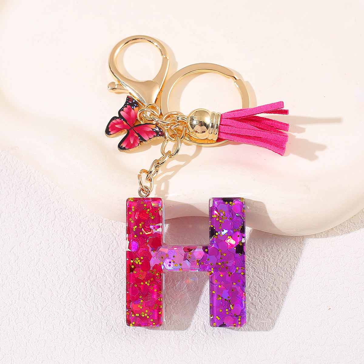 Transfronterizo Amazon 26 letras llavero de goteo de goma esquinilla gradiente letras mariposa llavero bolso de mujer colgante